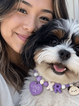 Owner and dog wearing custom beaded initial collar